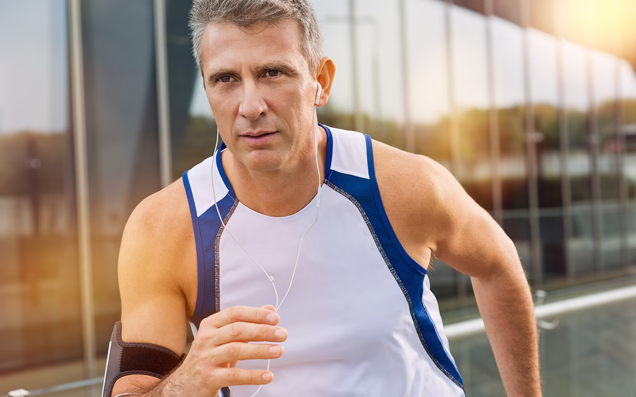 Fit man running outdoors, representing fitness and personal training benefits