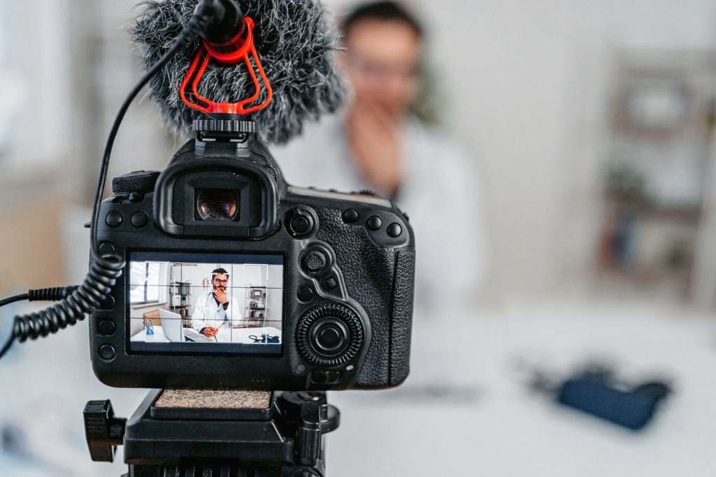 Professional camera and recording equipment filming a physician